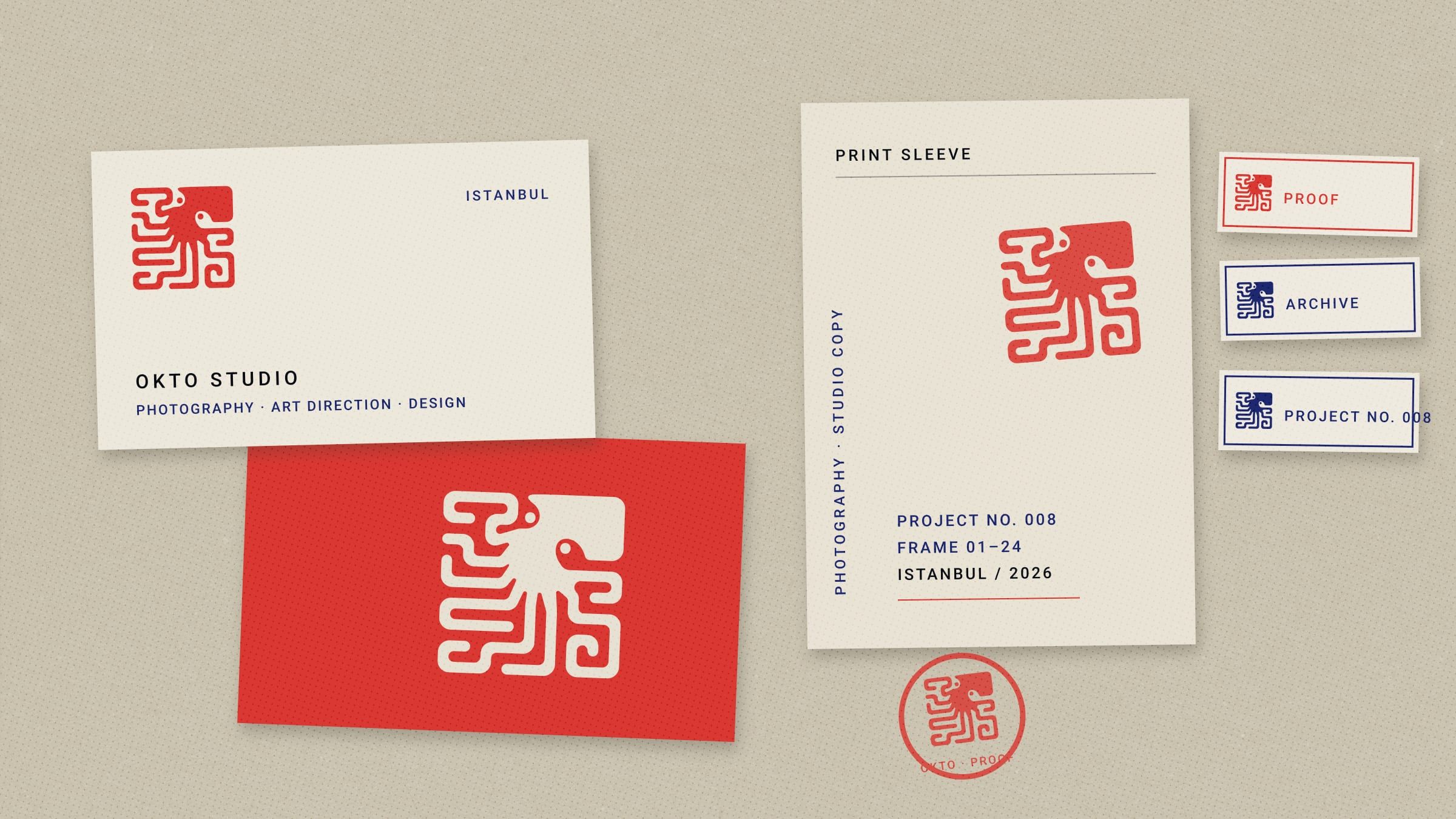 Studio cards, a print sleeve, archive labels and a stamp impression, seen from above
